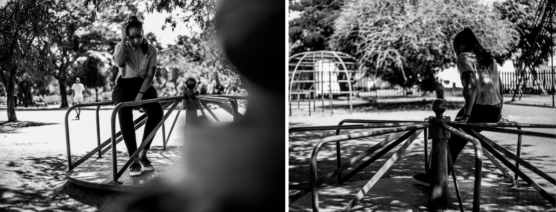 Young woman sits alone in a playground on a carousel, staring at the ground