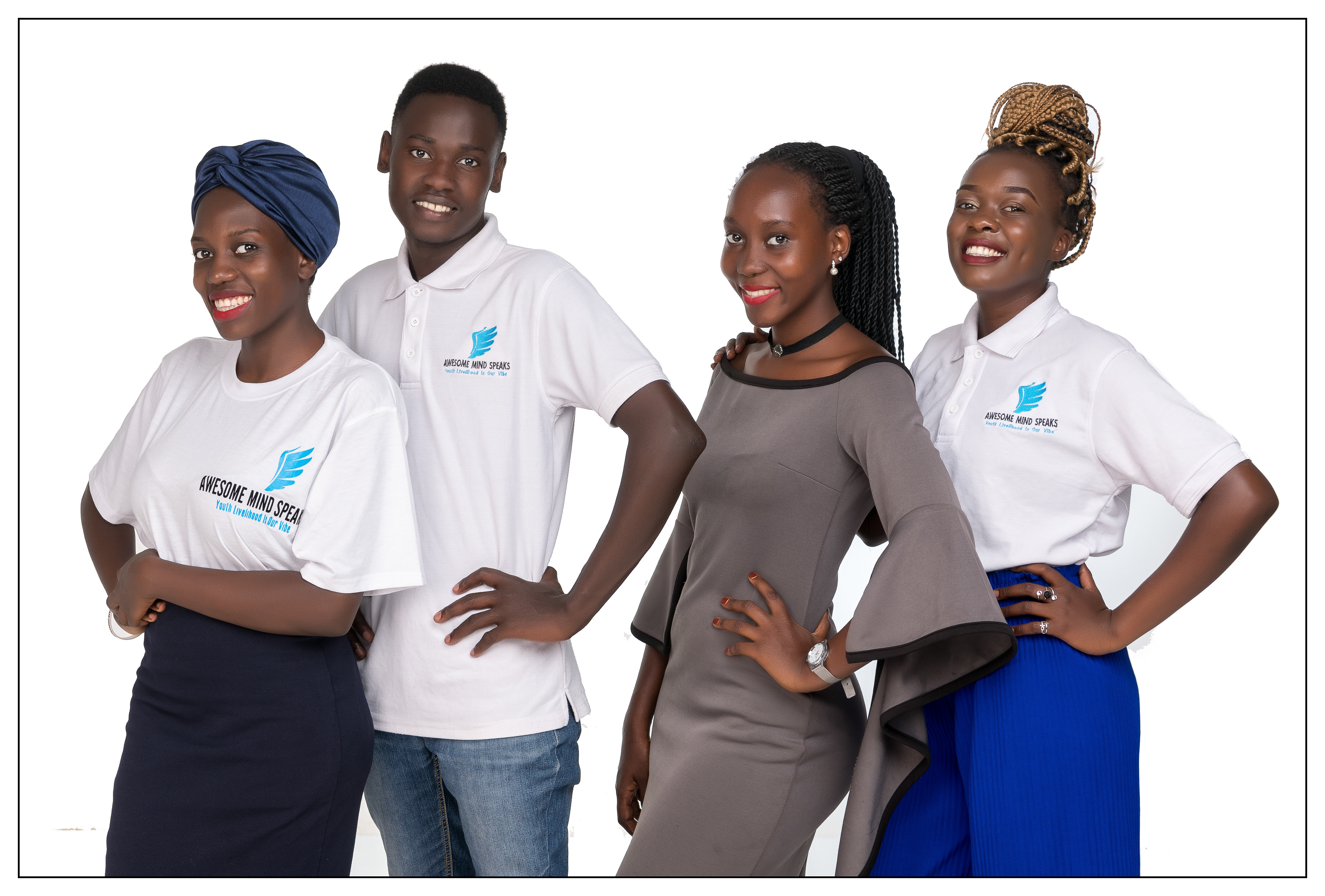 Three young black women and a young black man stand in a row smiling wearing t-shirts that say 'awesome mind speaks'